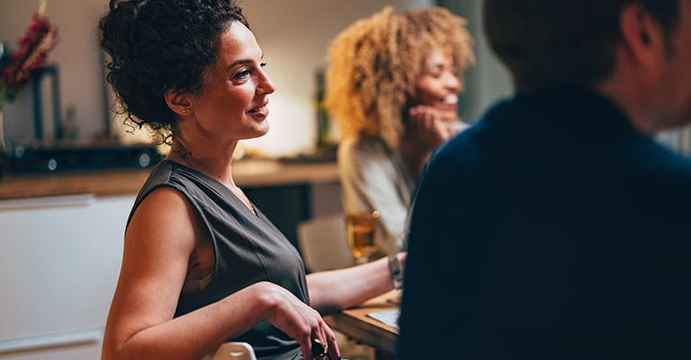 woman hanging out with her friends around a dining table
