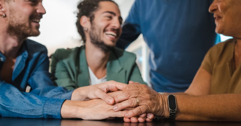 group of friends holding hands in support