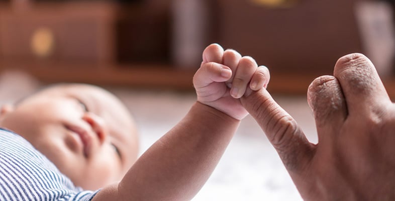 baby-grasping-adult-finger