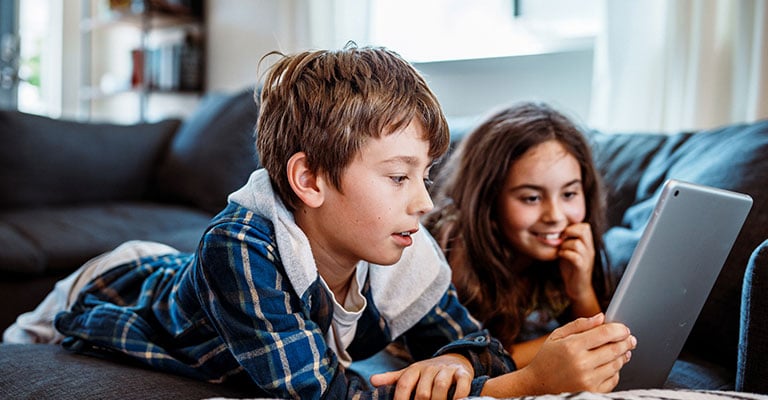 two children looking at iPad