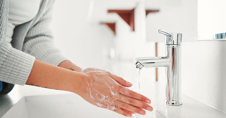 washing hands in sink