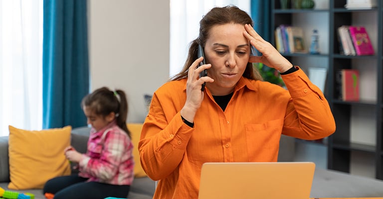 stressed mother on the phone at home