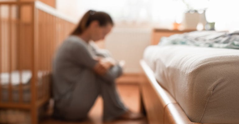 blurry image of woman that is feeling down