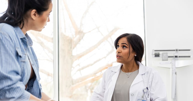 provider talking with her patient in exam room