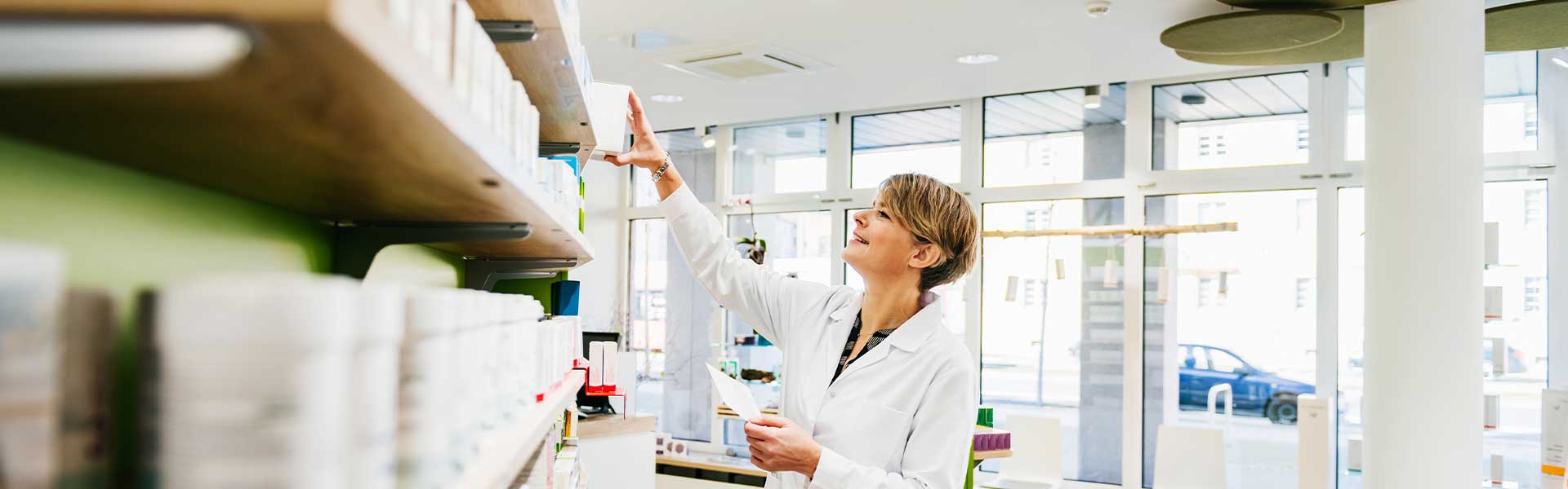 Pharmacist-reaching-for-shelf