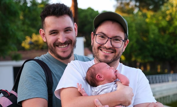 gay male couple with their newborn
