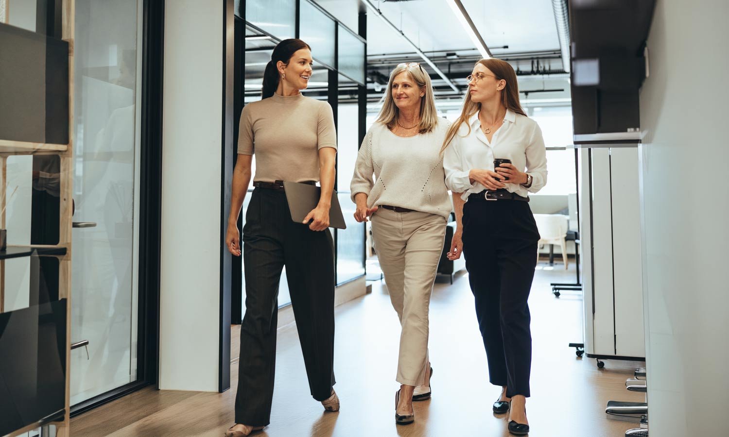 three-female-colleagues-striding-at-the-office-1500px