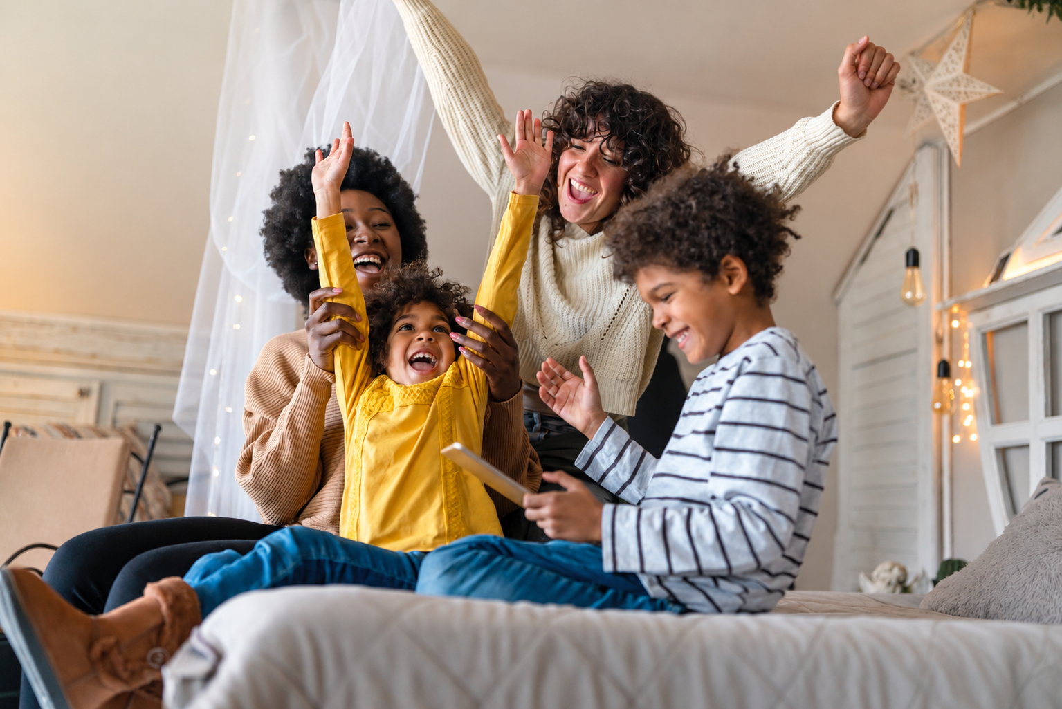 joyful family of four celebrating at home