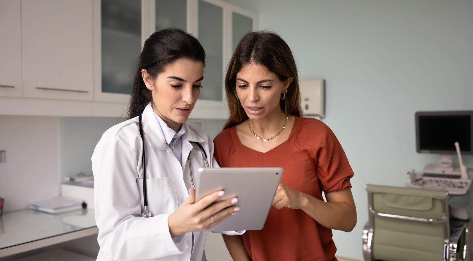 clinician-reviewing-tablet-with-patient