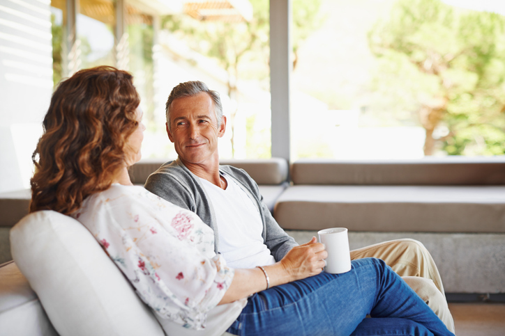 couple seated on their porch in the morning