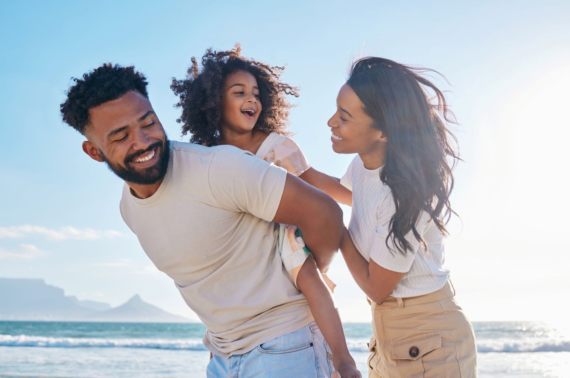 happy-family-of-three-by-the-beach