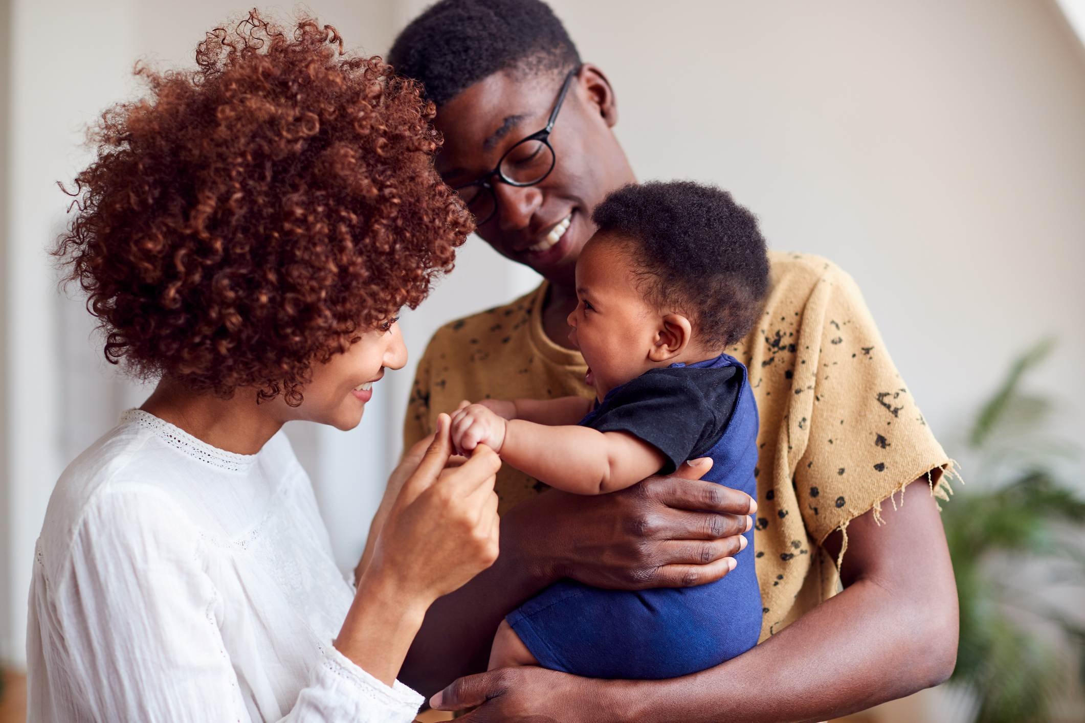 happy-family-of-three-holding-young-baby