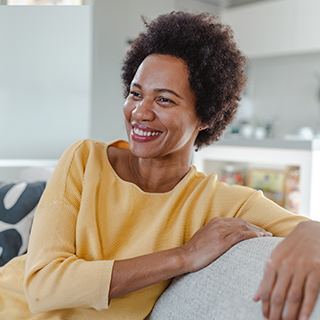 woman in midlife relaxing on sofa