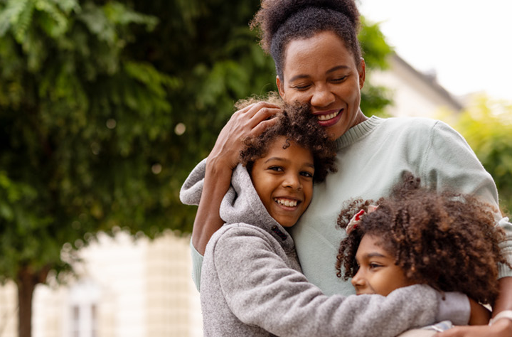 mother-hugging-her-two-children
