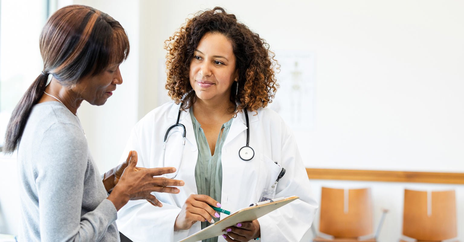 Black female doctor listening carefully to patient