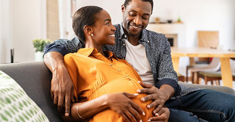 pregnant woman smiling at partner