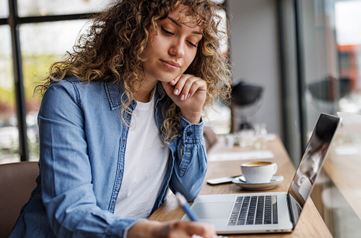 woman at work seated by her laptop