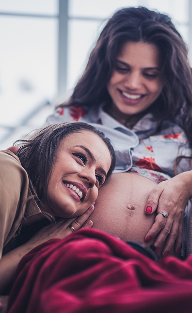 two women hanging out, one pregnant