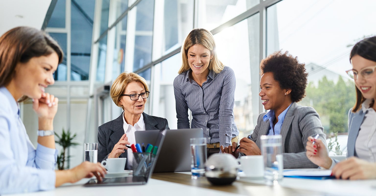 happy businesswomen working on laptops in the office
