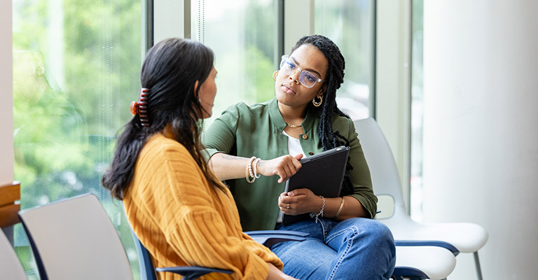 person listening to colleague with interest