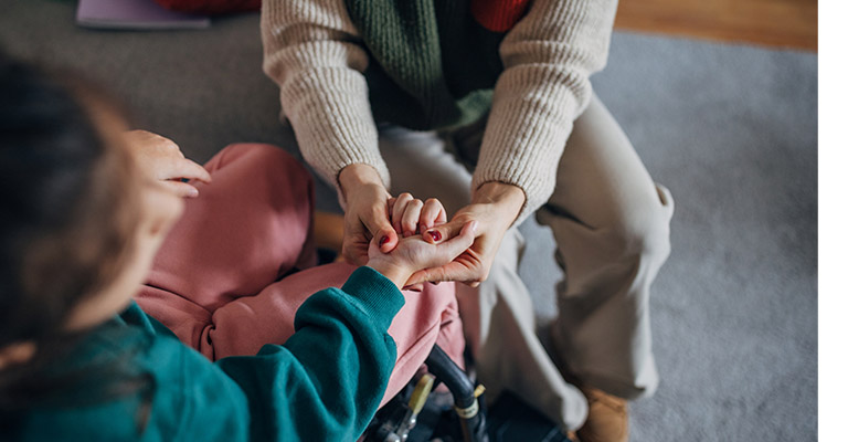 closeup of mother daughter grasping hands