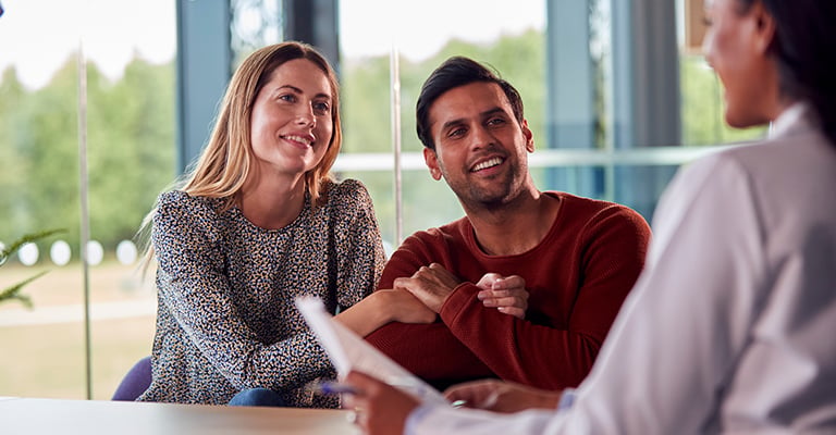 couple looking animatedly at provider