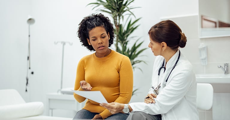 doctor reviewing paperwork with patient