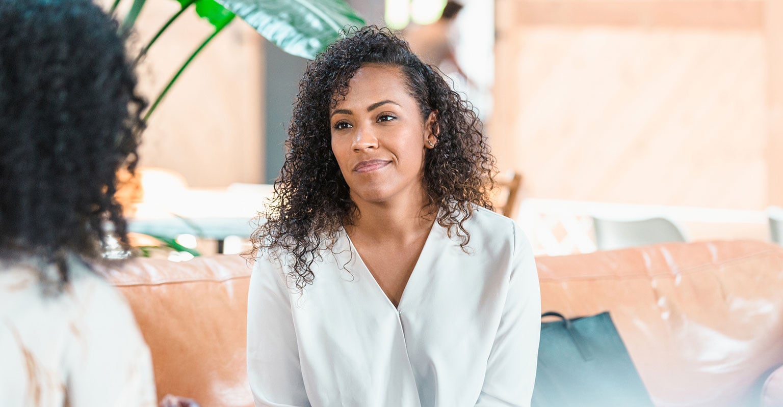 woman with curly hair looking at her provider