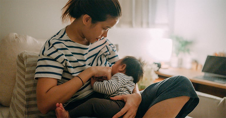 woman breastfeeding her baby