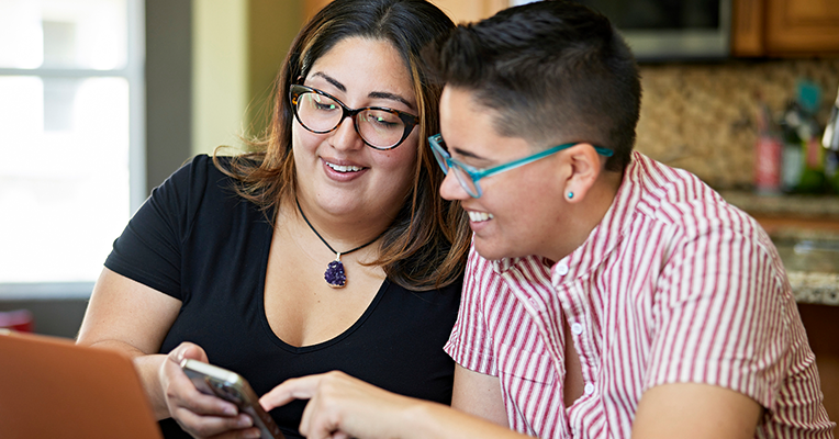two women looking at a cell phone