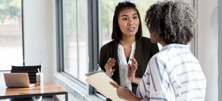 woman discussing benefits with her colleague