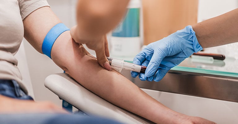 personal getting blood drawn at the medical office
