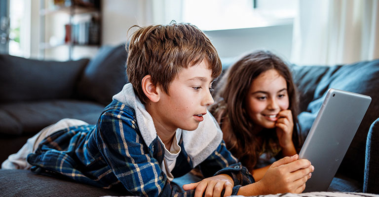 two children looking at iPad