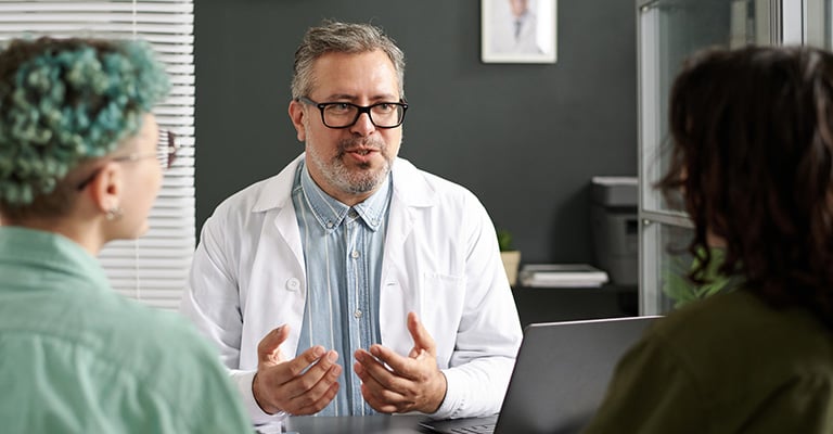 doctor gesturing while explaining something to his patient