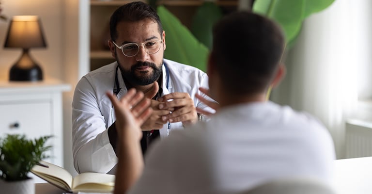 male discussing his medical issues with provider