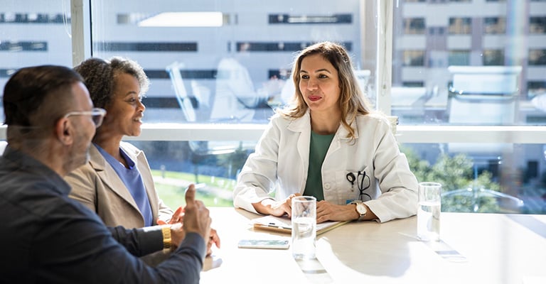 patients meeting with doctor in a light-filled office