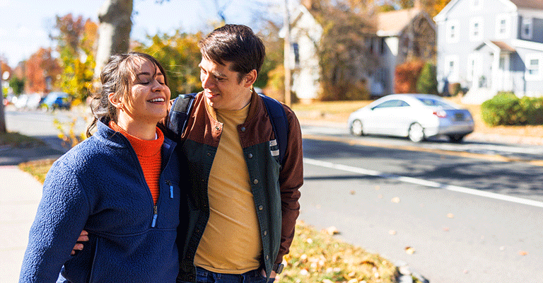 a heterosexual couple walking on an autumn day