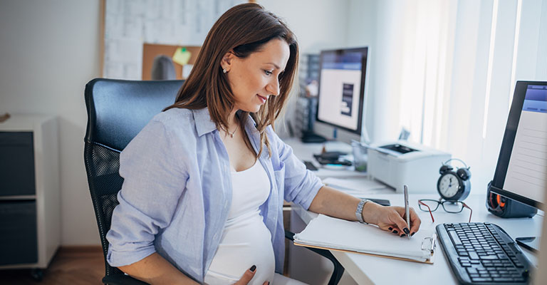 pregnant woman preparing a plan on paper