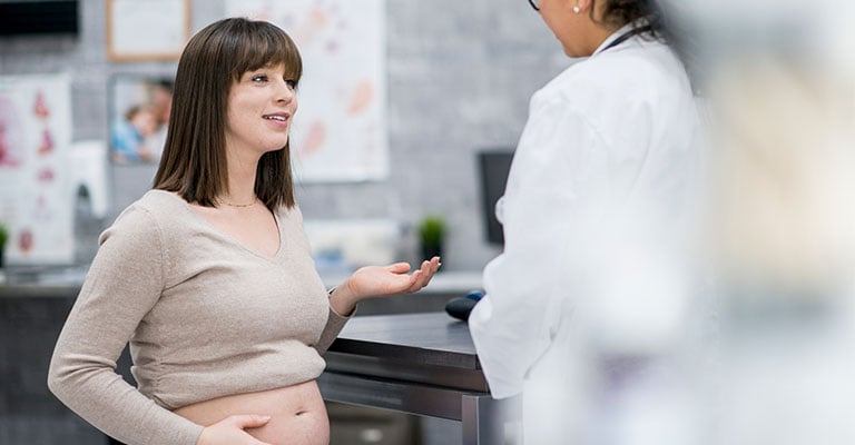 young pregnant woman at doctor's office