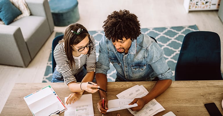 woman reviewing paperwork with her partner