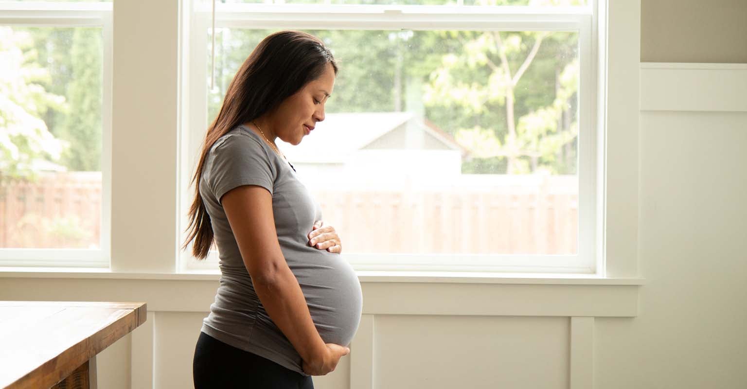 pregnant woman holding her belly