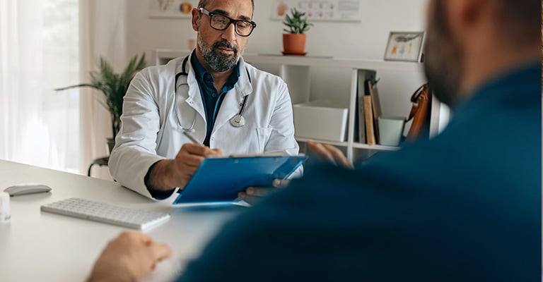doctor taking notes during an appointment