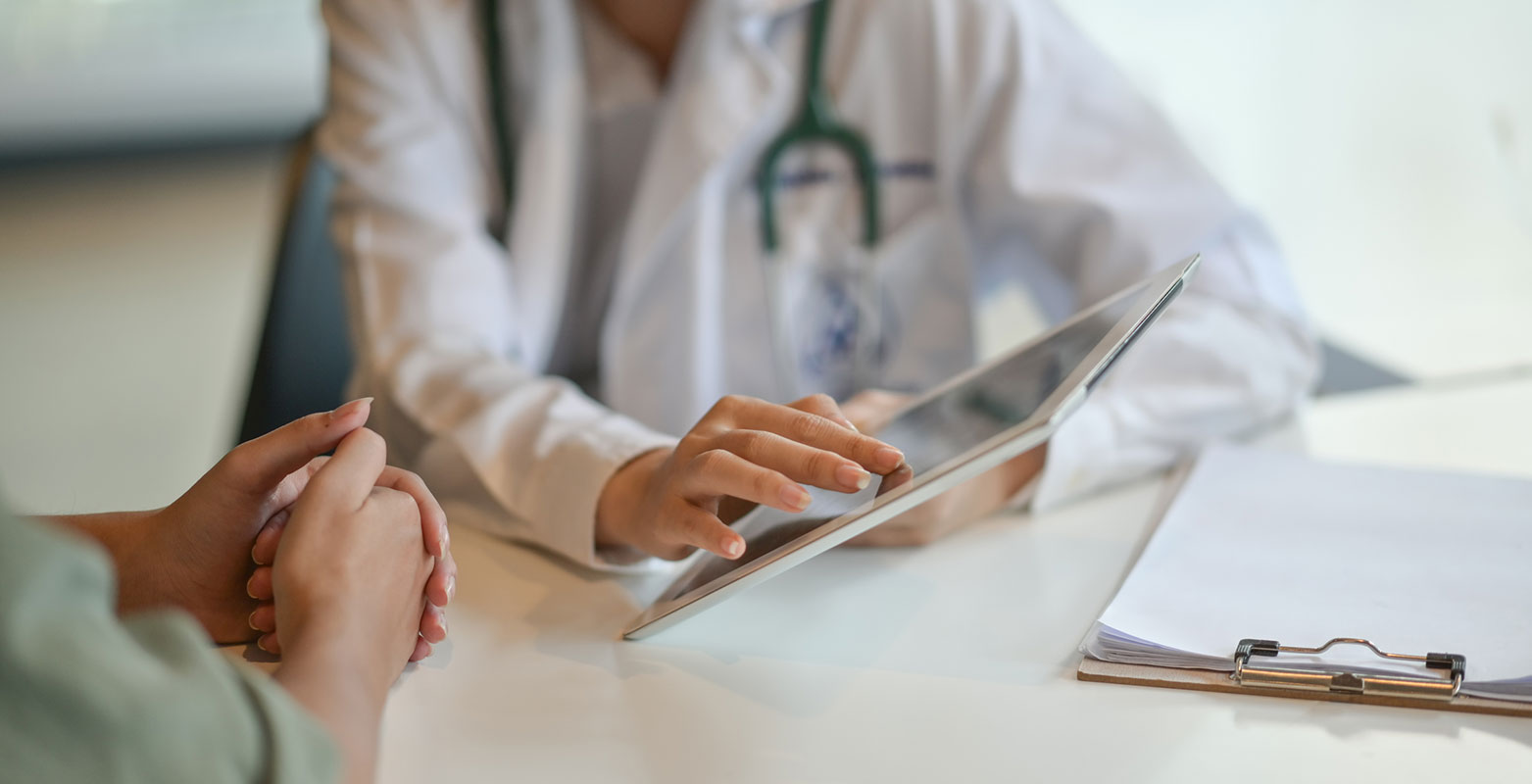 doctor showing patient something on iPad