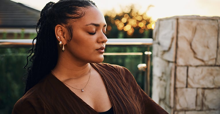 woman with closed eyes practicing mindfulness