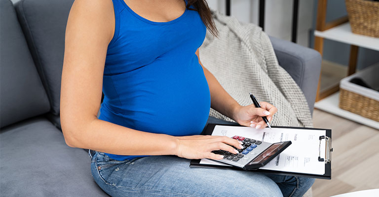 pregnant woman using a calculator