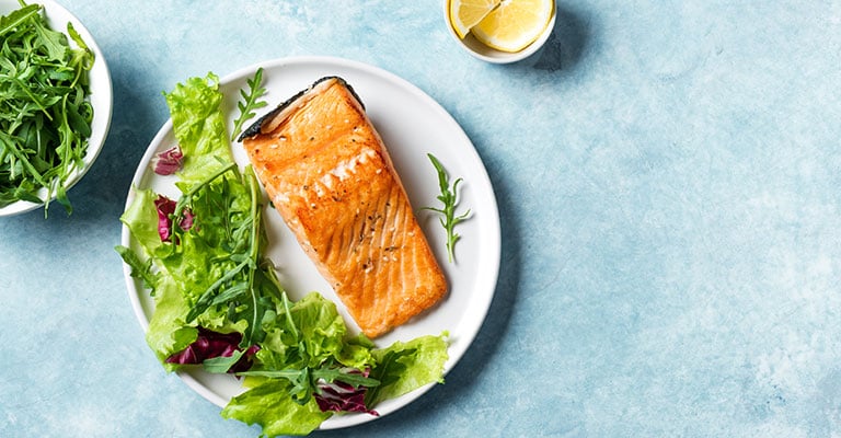 salmon and salad on a plate