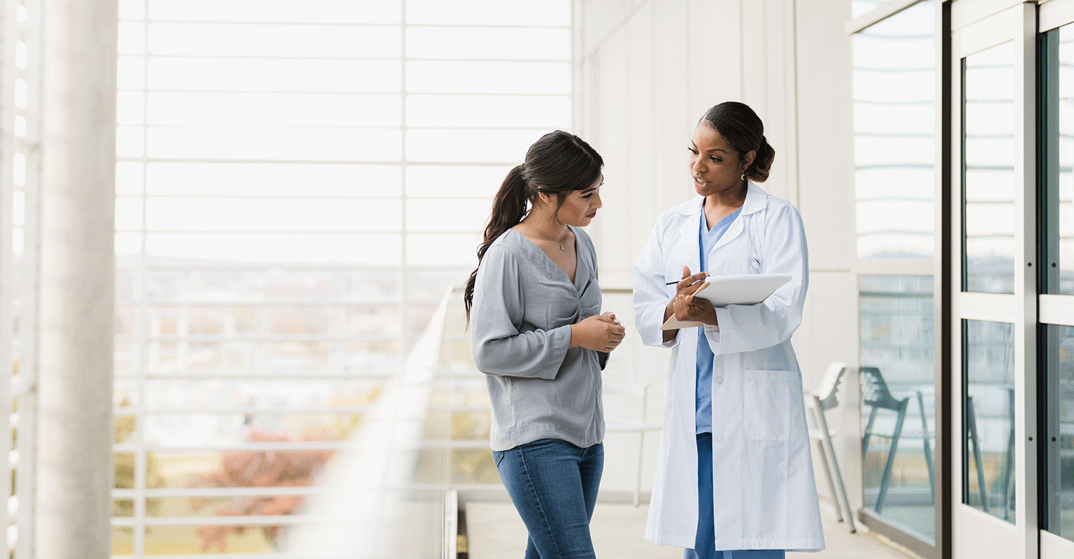 provider talking with patient in the hallway