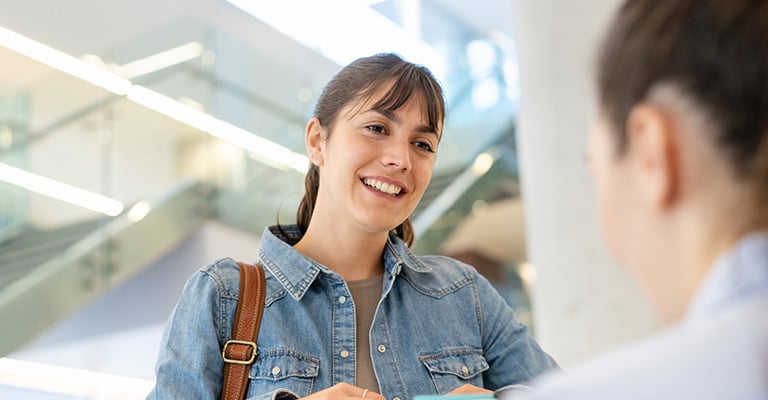 woman checking into appointment at fertility clinic