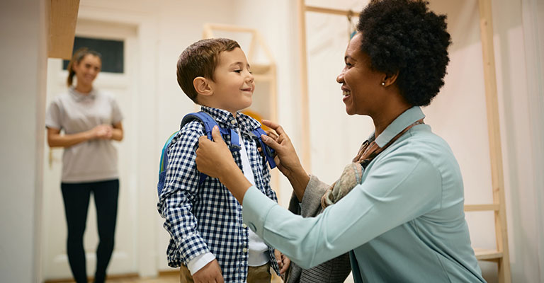 young boy getting ready for school dropoff