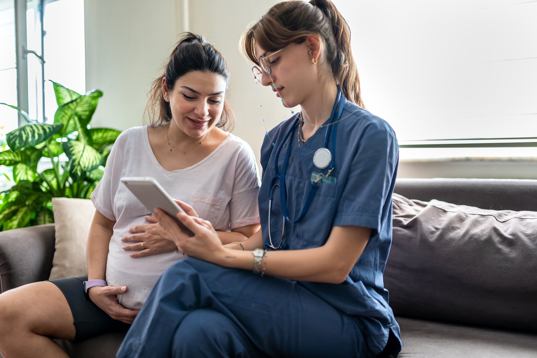 home health nurse visiting with pregnant patient